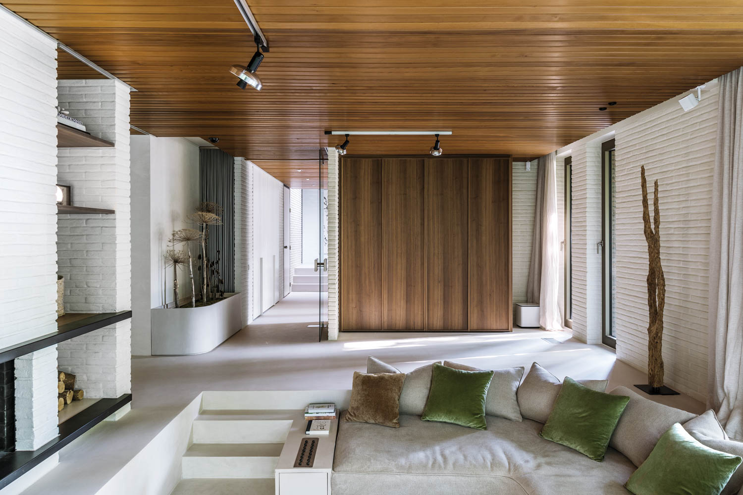 a conversation pit in a home with whitewashed walls