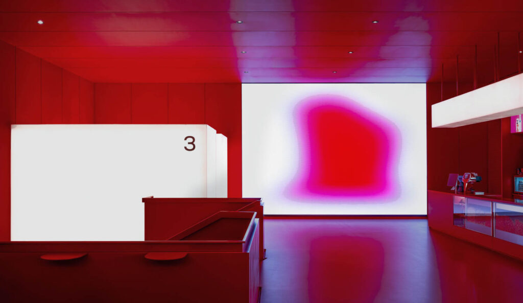 signature red walls in Mirage Cinema by Da Bureau