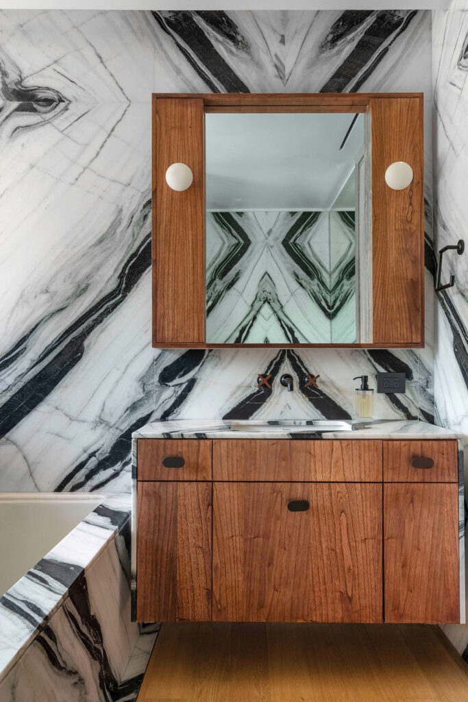 a black and white marble on the walls of the main bathroom