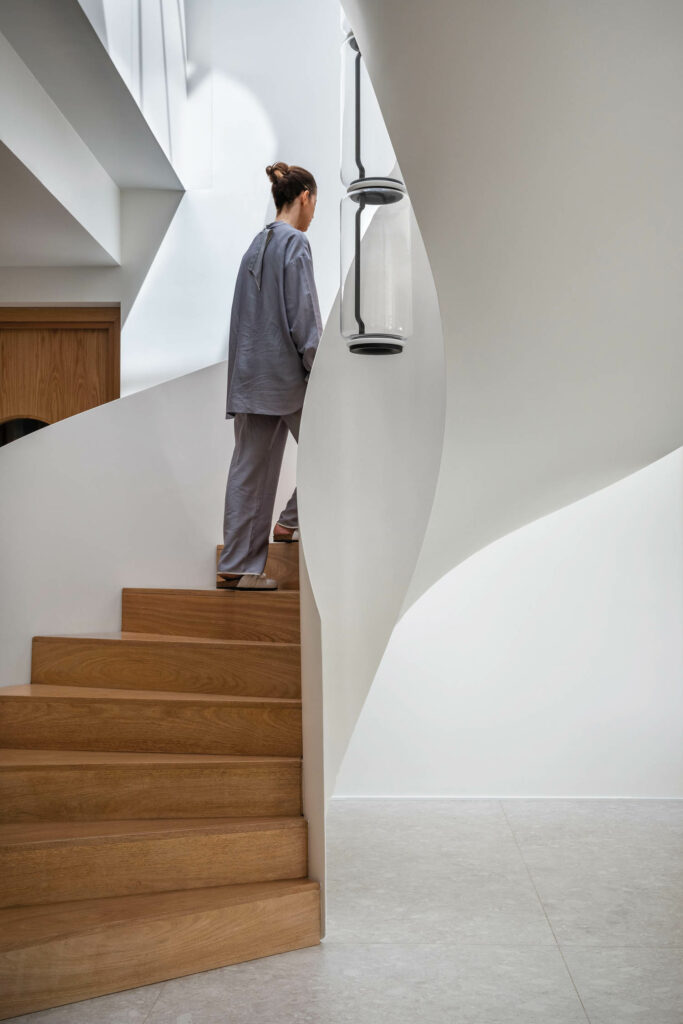 a person walks up a white paneled staircase