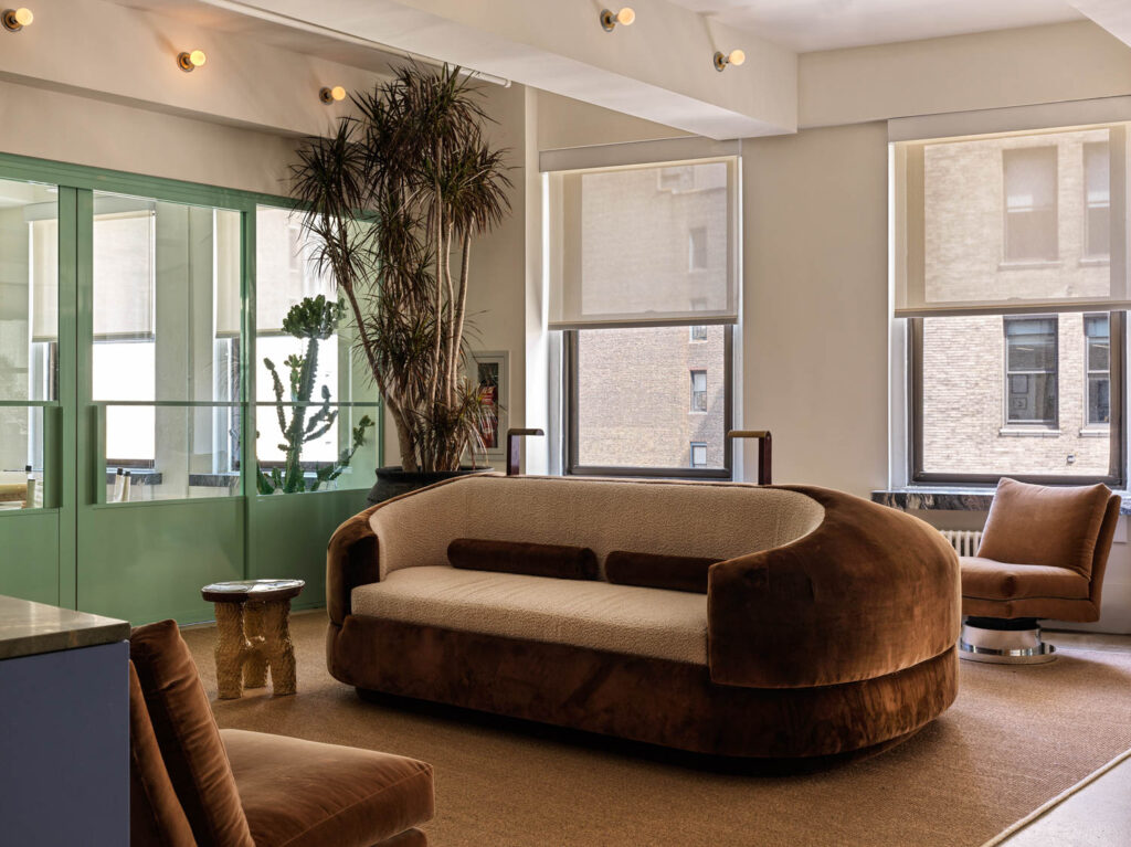 A brown velvet couch in the lounge at Sandbox Films