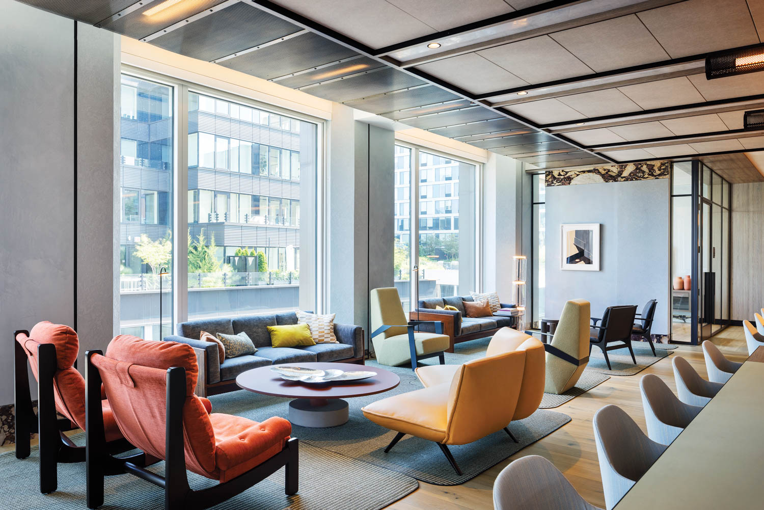 a lobby with orange and red chairs