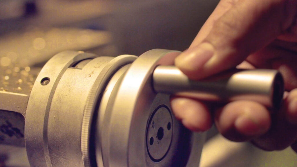 a person adding final touches to a brass fixture