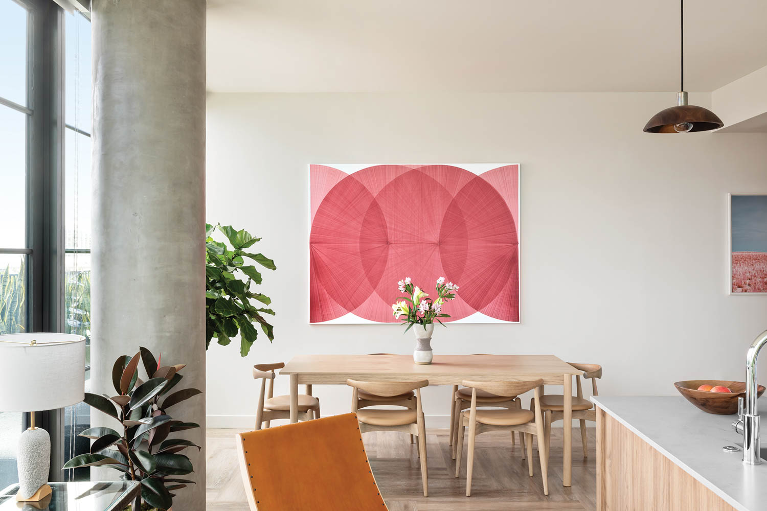 a read artwork above a wooden dining table