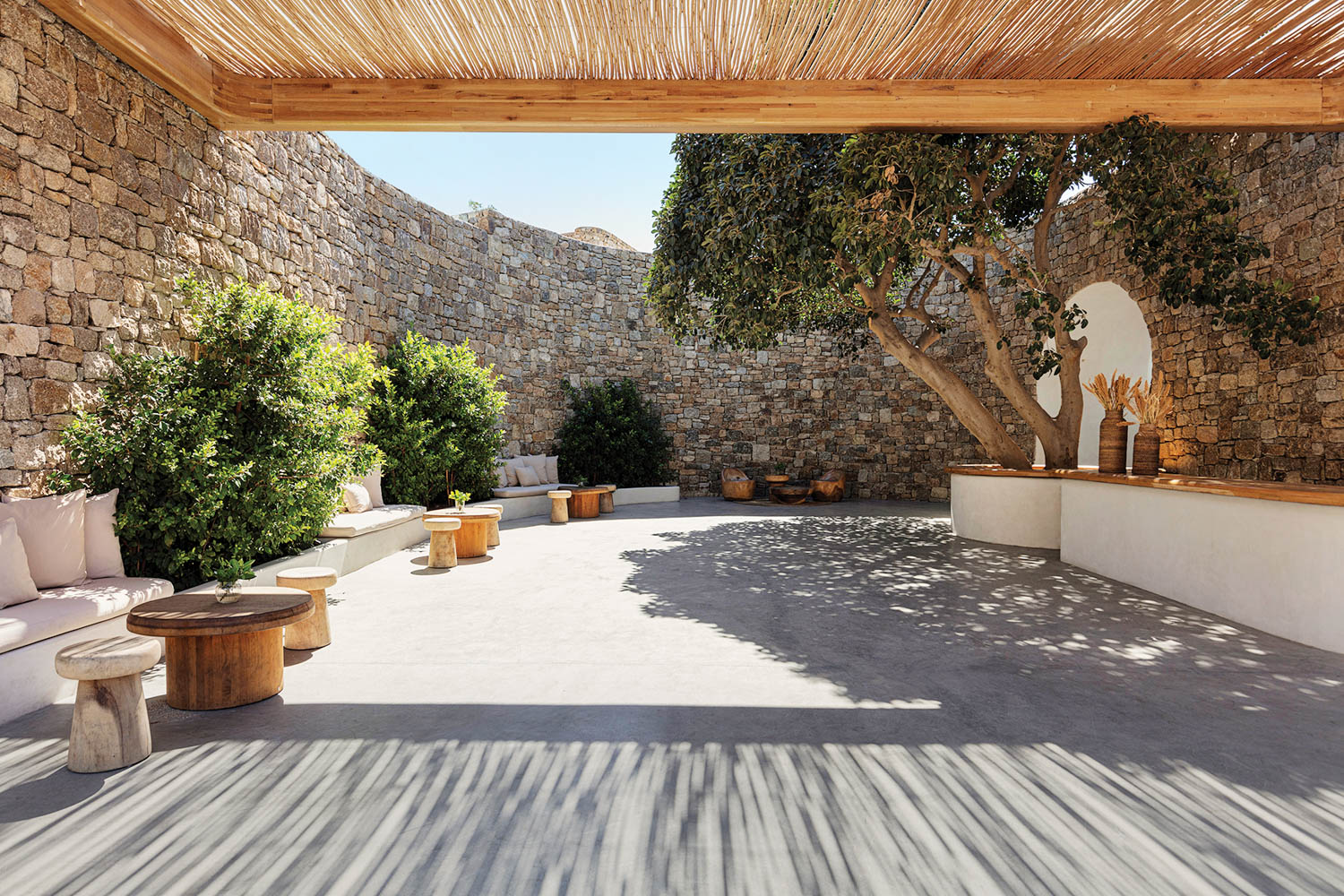 an outdoor patio surrounded by stone walls