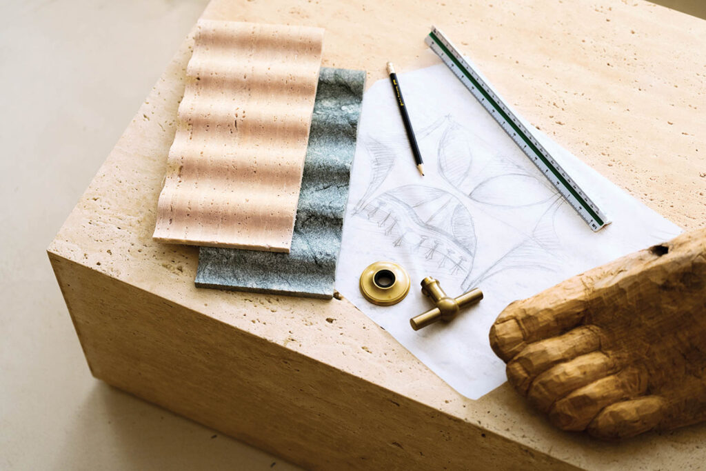 natural materials and sketch paper sit atop a coffee table in this office