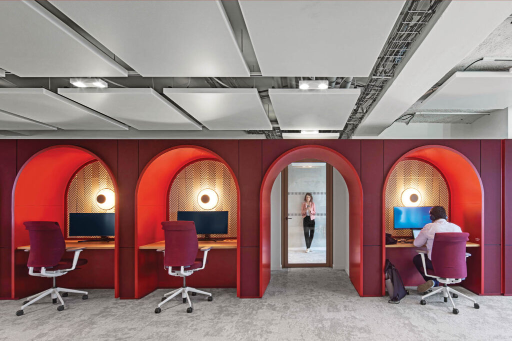 red arched recesses offer workstations at this office space