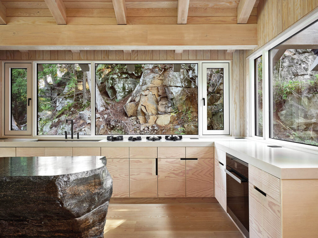 an unfinished granite block that serves as a kitchen island in a small country home