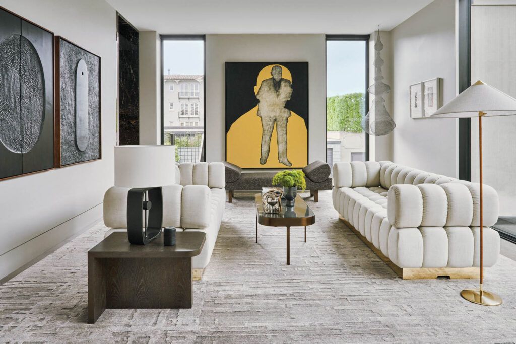 a neutral toned living room with a painting on one wall