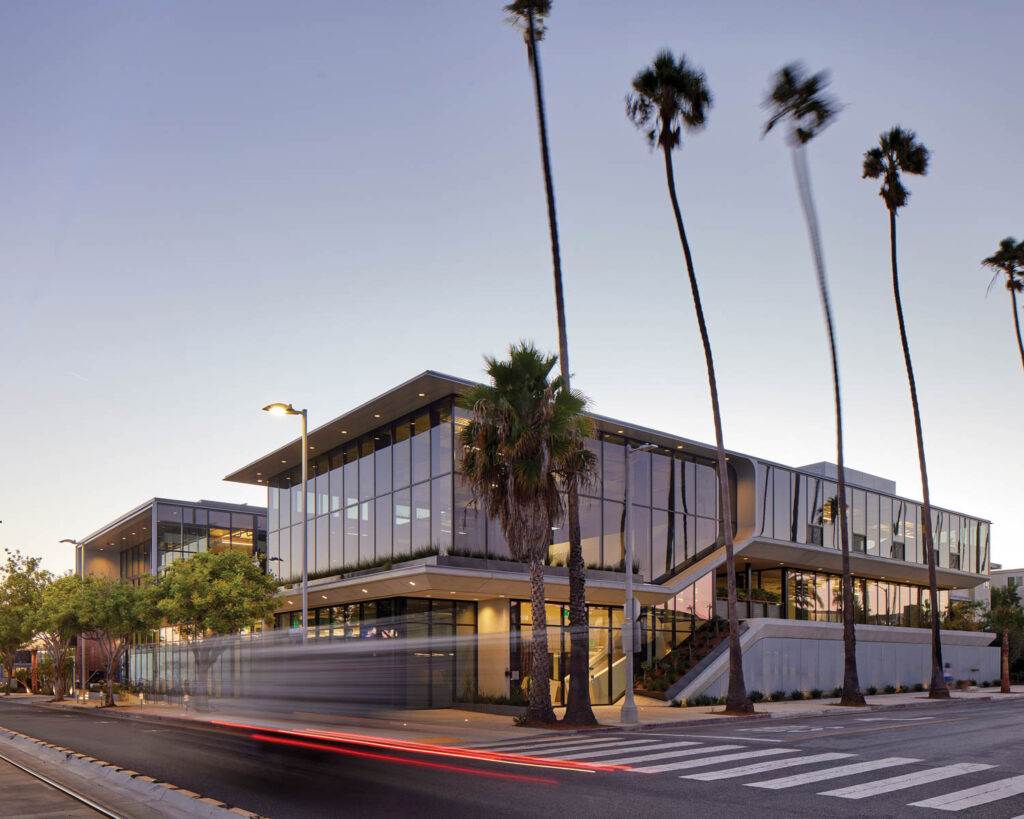 the exterior of an office surrounded by palm trees