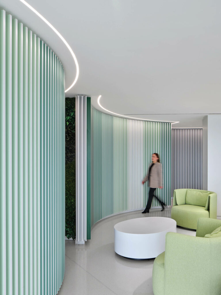 hallway with green divider and lime green couches