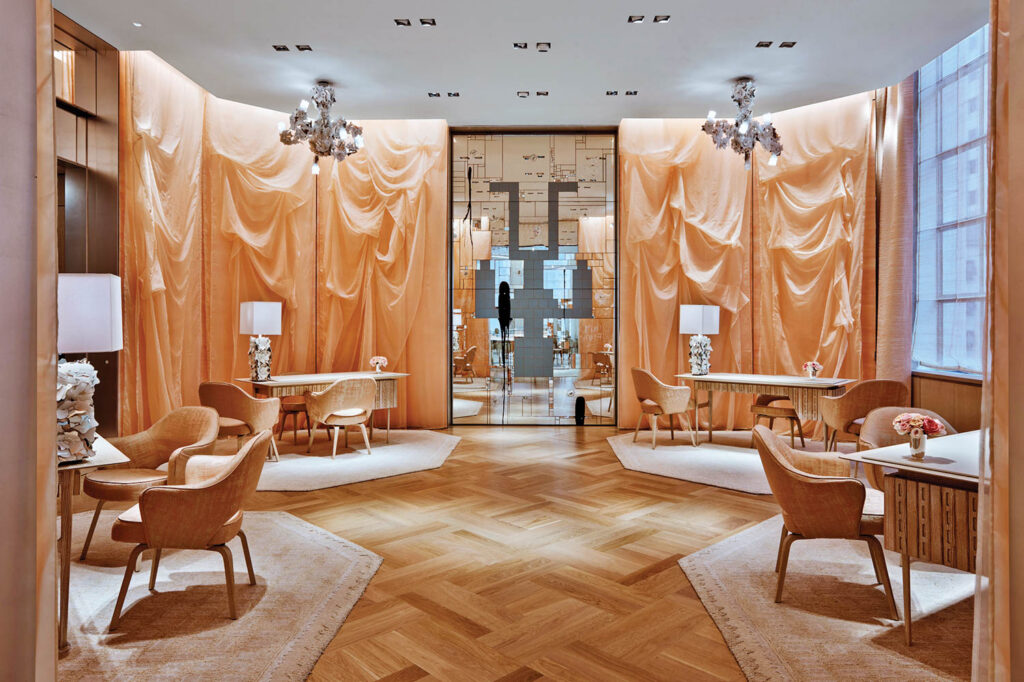 a room with wood floors and cream curtained walls in Tiffany & Co