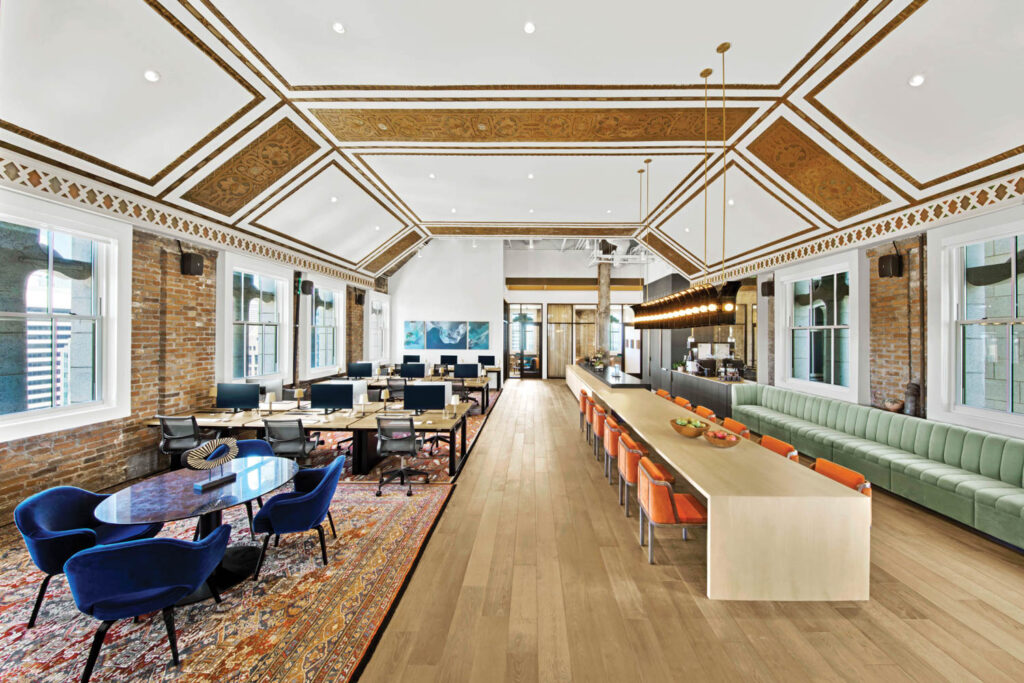 dining room lobby with midnight blue armchairs on one side and dining area on another