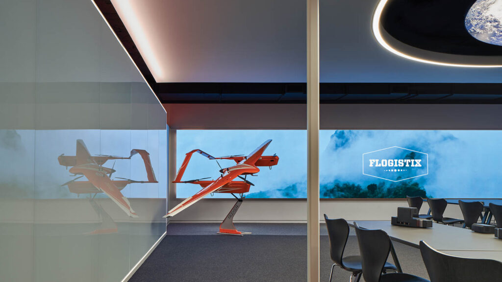 conference room with bright blue screen and orange statue