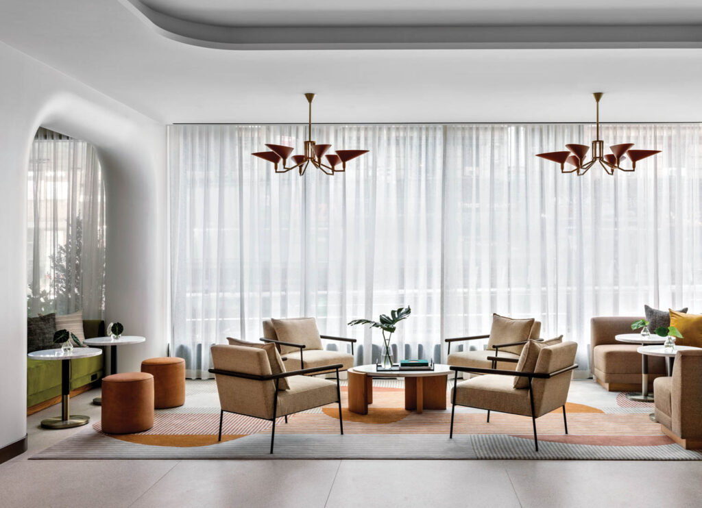 living room with tan chairs and orange carpets