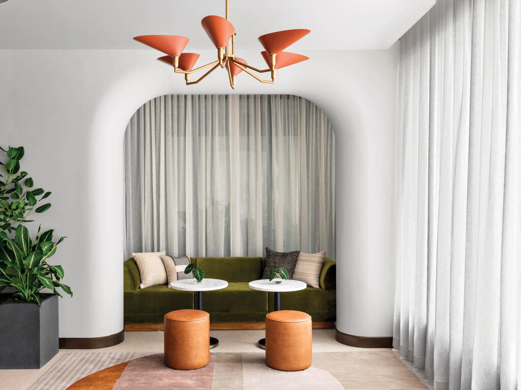 sitting room with seating nook and dark olive green and orange chandelier