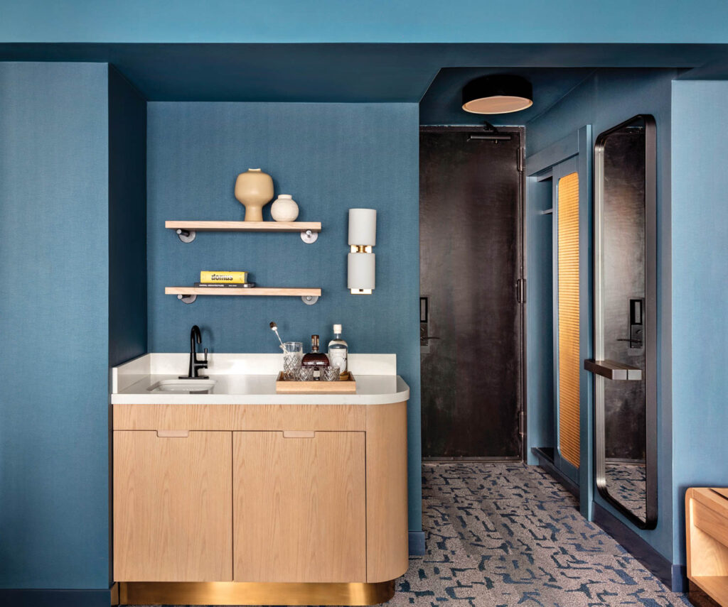 dark blue bar with wooden vanity and shelves