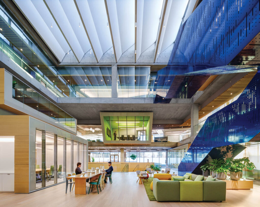 Town hall pavilion with high ceilings, green chairs and blue stairs