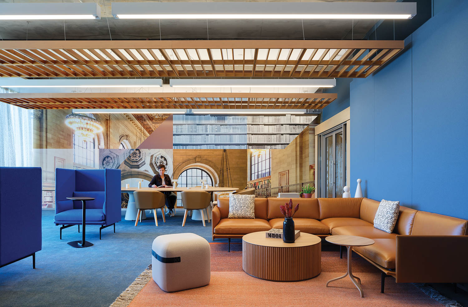 Room with bright orange sofa and blue chairs