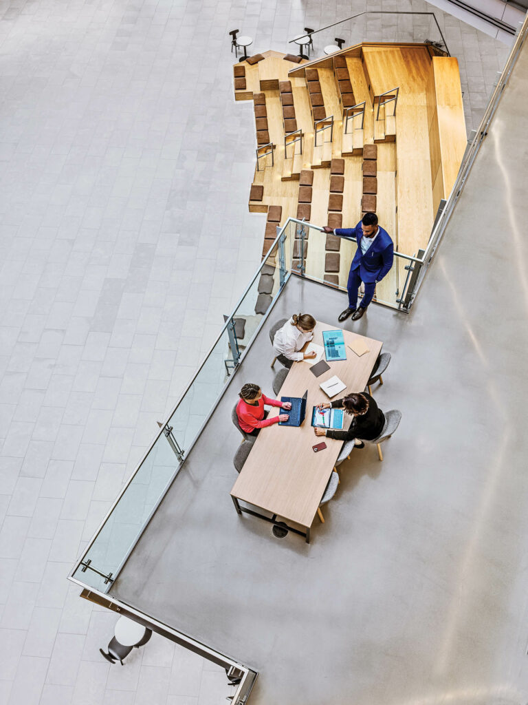 aerial view of an internal balcony with people sitting at the tables