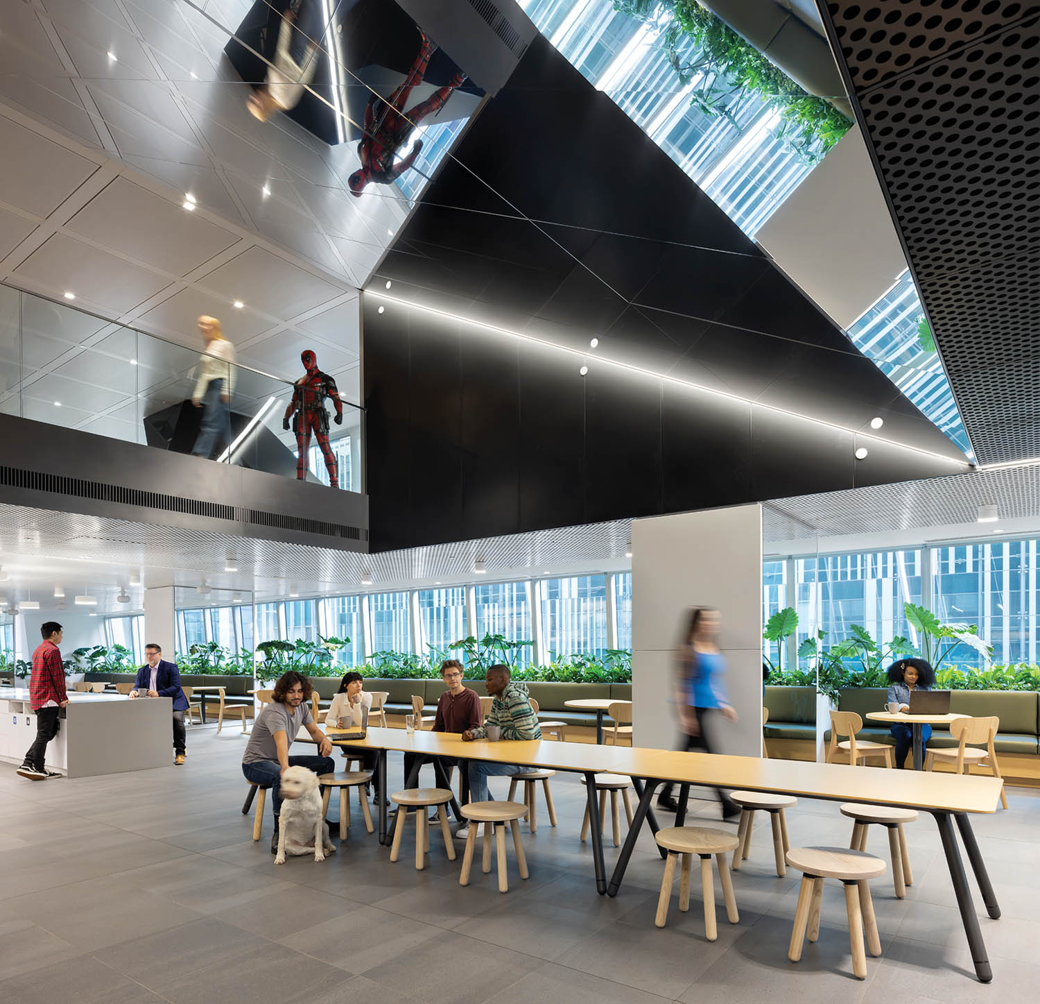 dining area with large black panels hanging from ceiling and lots of greenery