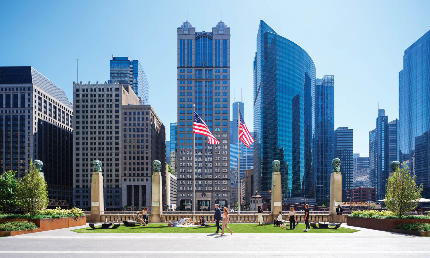 exterior shot of skyscrapers with American flags