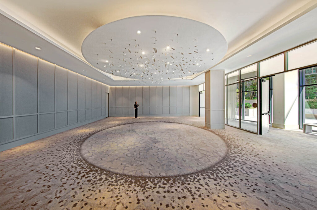 ballroom with large white ceiling fixture and a hand-tufted rug