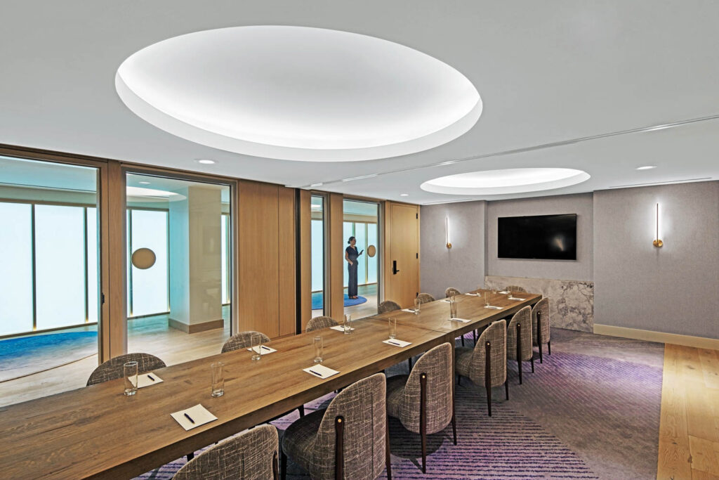 meeting room in the conference center with a circular light sconce and long wooden table