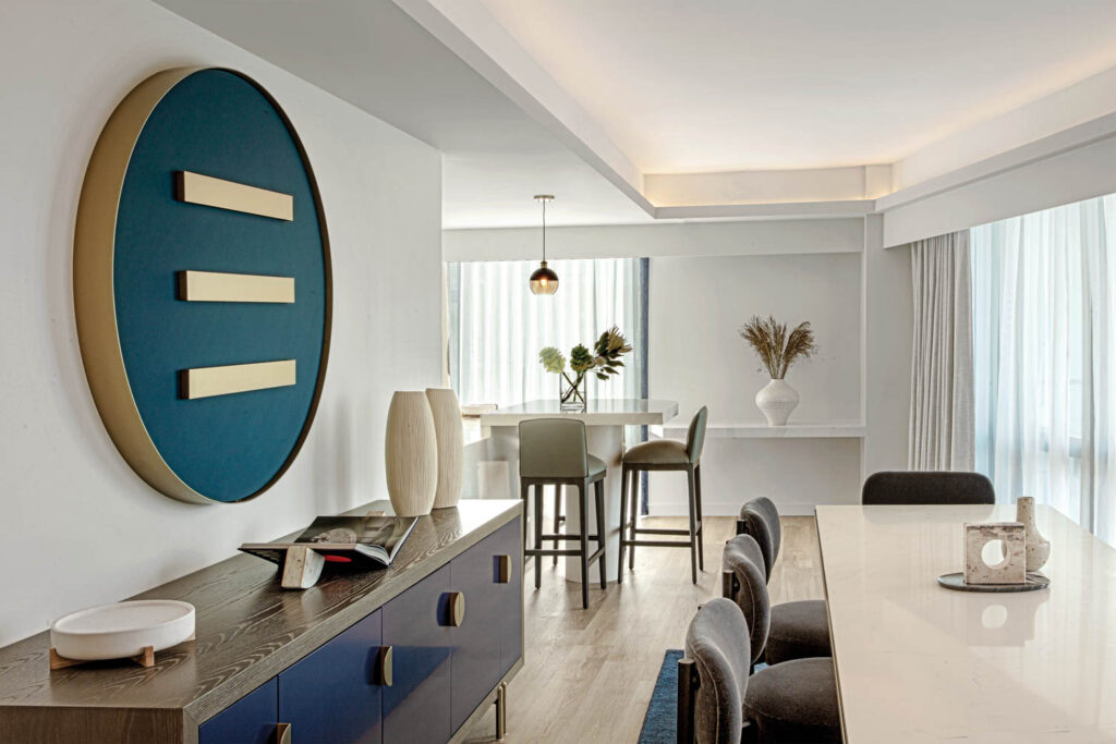 dining area within a suite with long dining table, custom light fixture and console