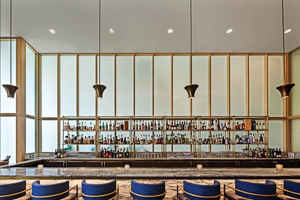 corner of the hotel restaurant with a marble-topped bar and pendant fixtures