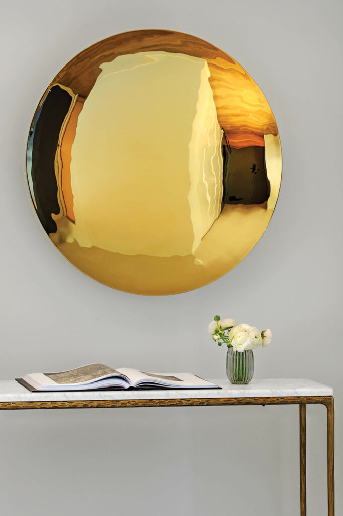 dining area niche of the suite with a table and gold mirror