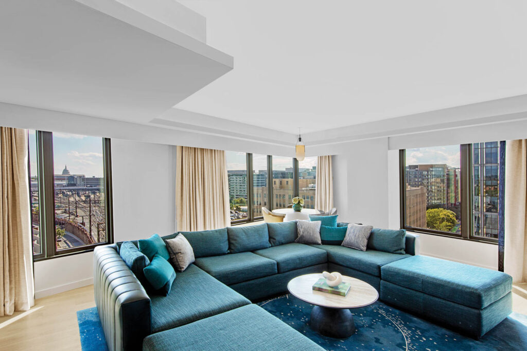 living room with a blue sofa and views of the city