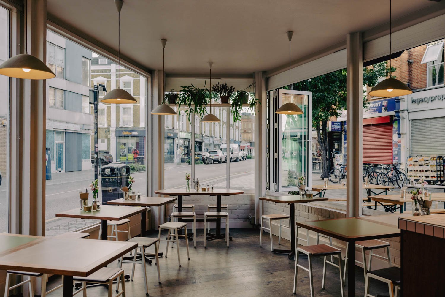 seating area inside Milk Cafe London with bright light and windows