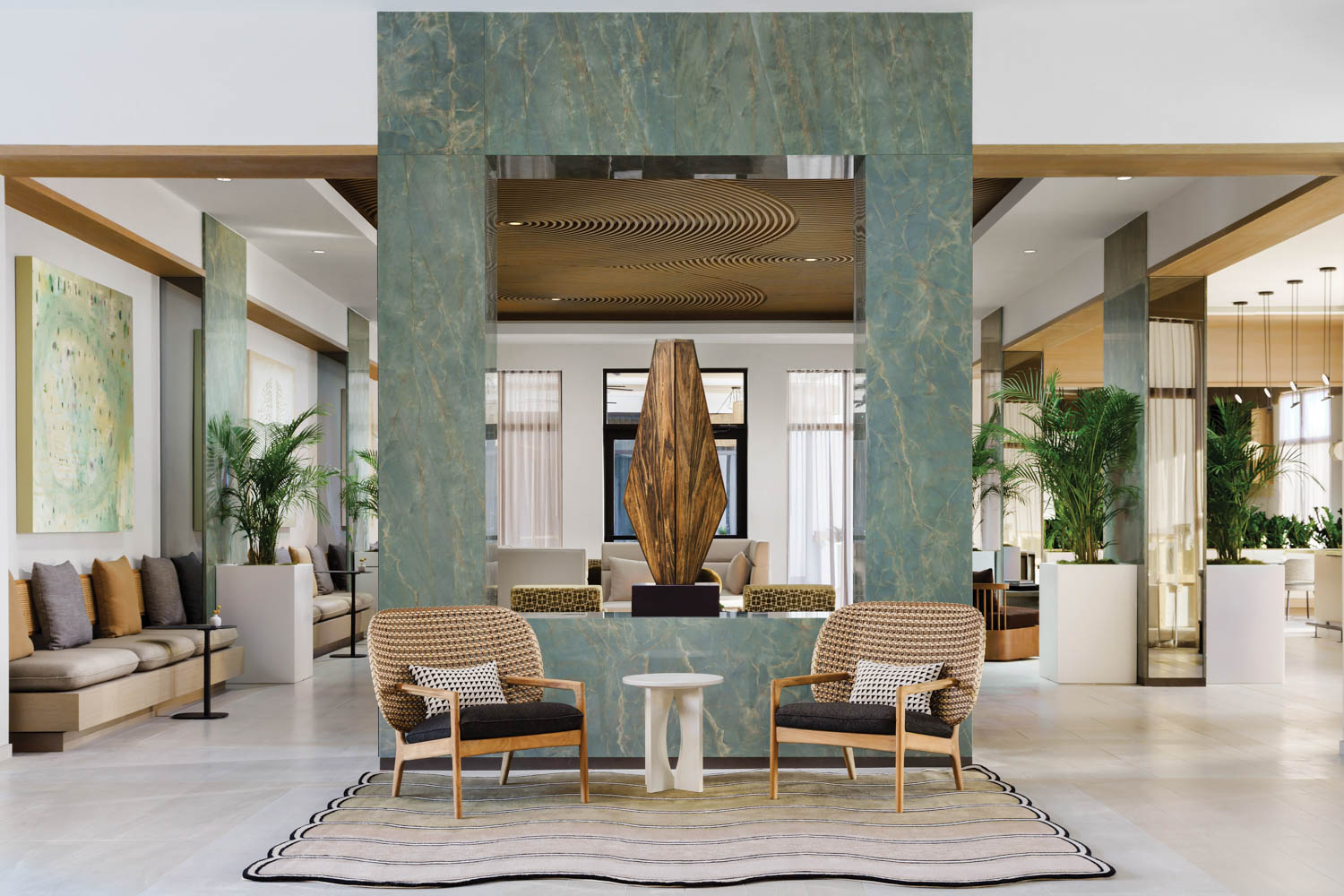 corner of lobby with aqua blue structure and fountain in the middle