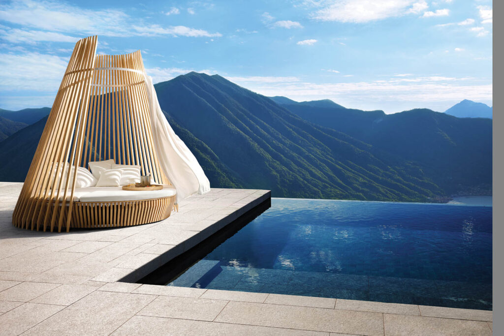 an infinity pool with mountain views and a daybed