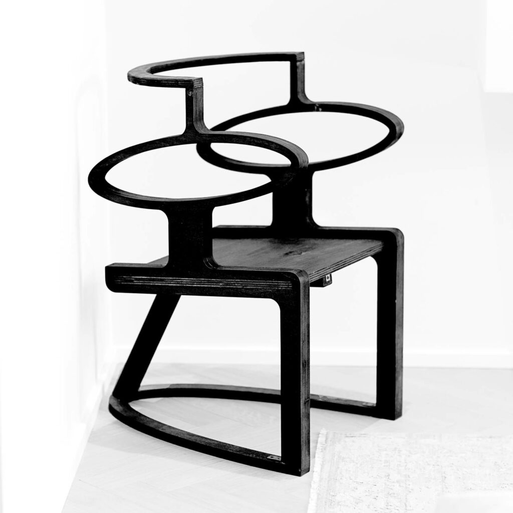 black chair with large holes and minimalist structure