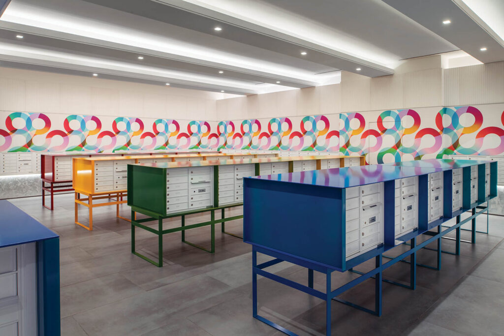 rainbow colored mailroom with bright wall designs referencing vinyls