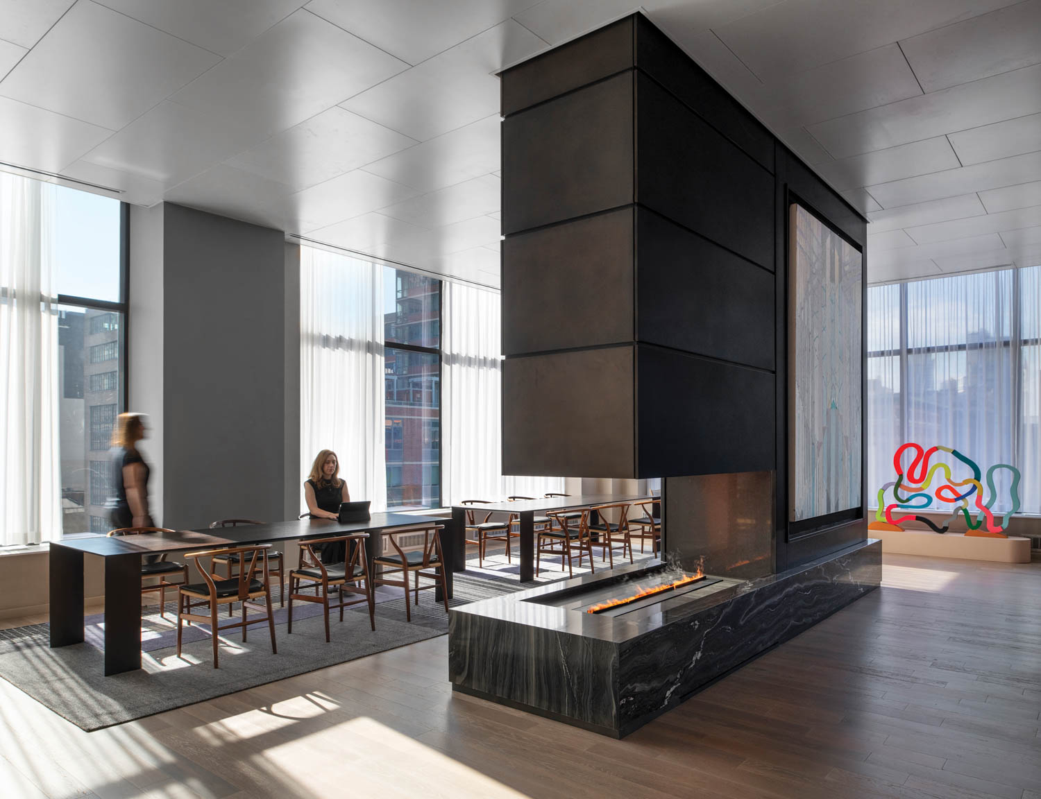 coworking library with blackened-steel fireplace