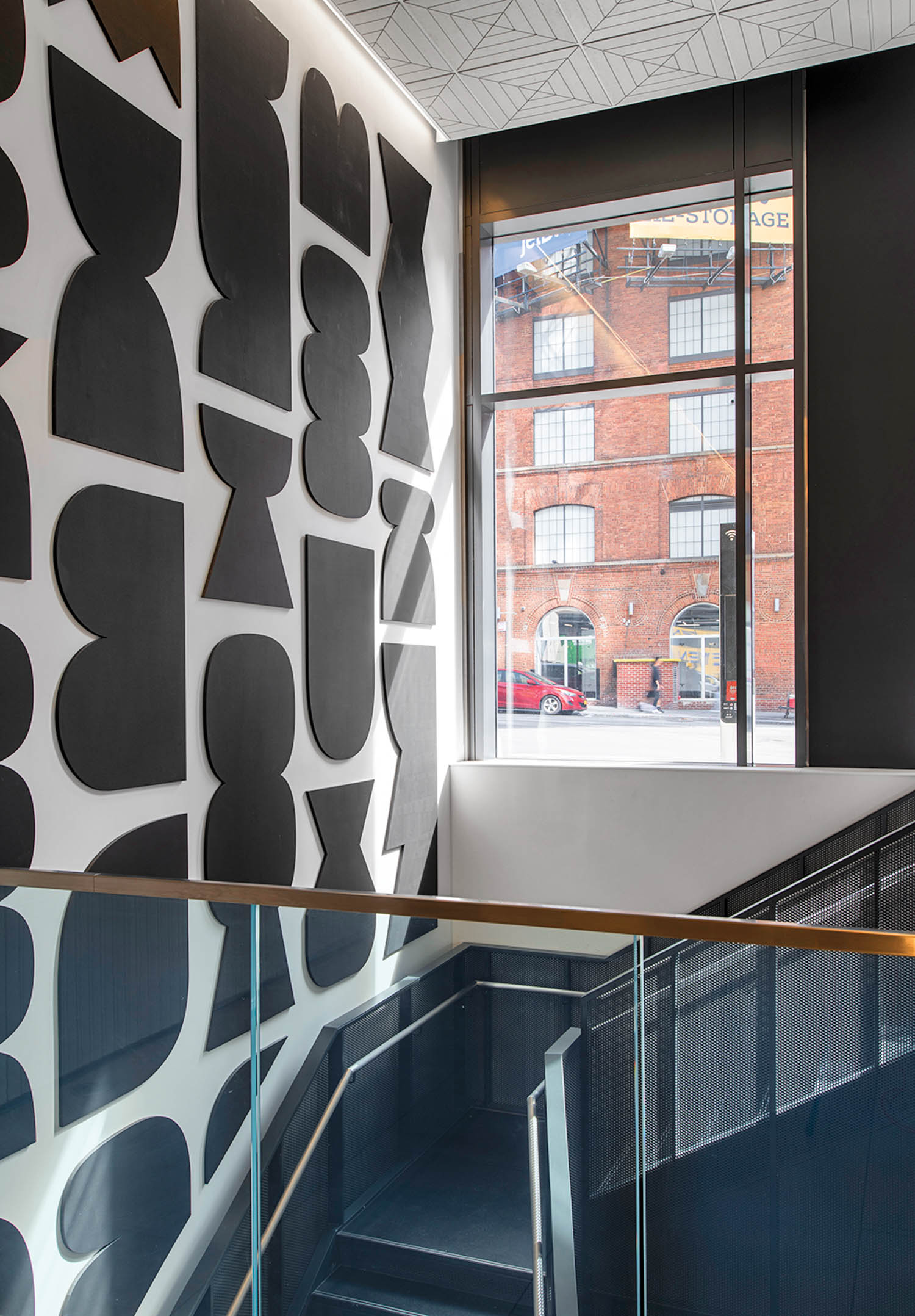 lobby stairwell with a patterned mural