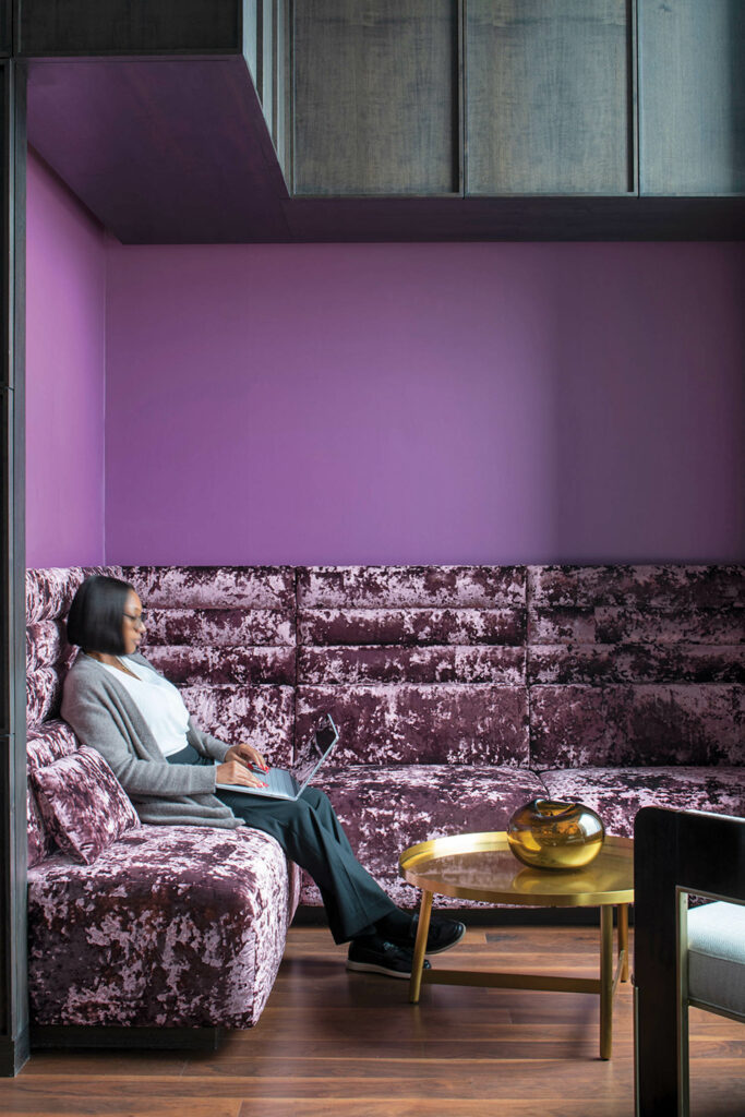 sky lounge with purple walls and crushed velvet banquette