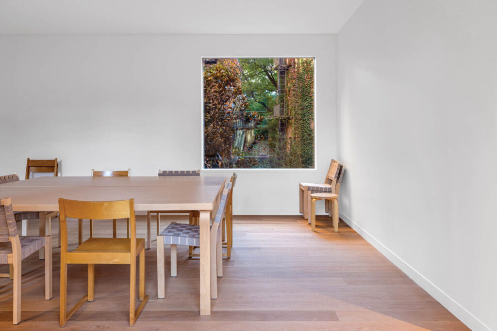 artist studio with lots of chairs and table and view of outdoors