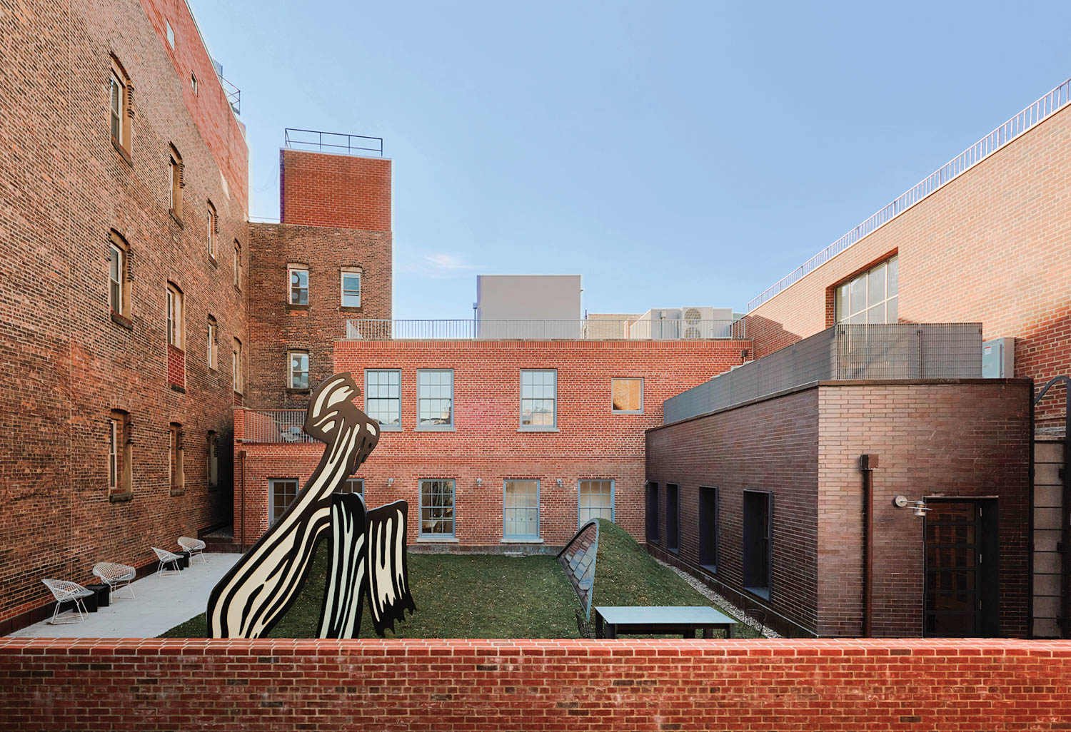 existing terrace with concrete sculpture and brick wall