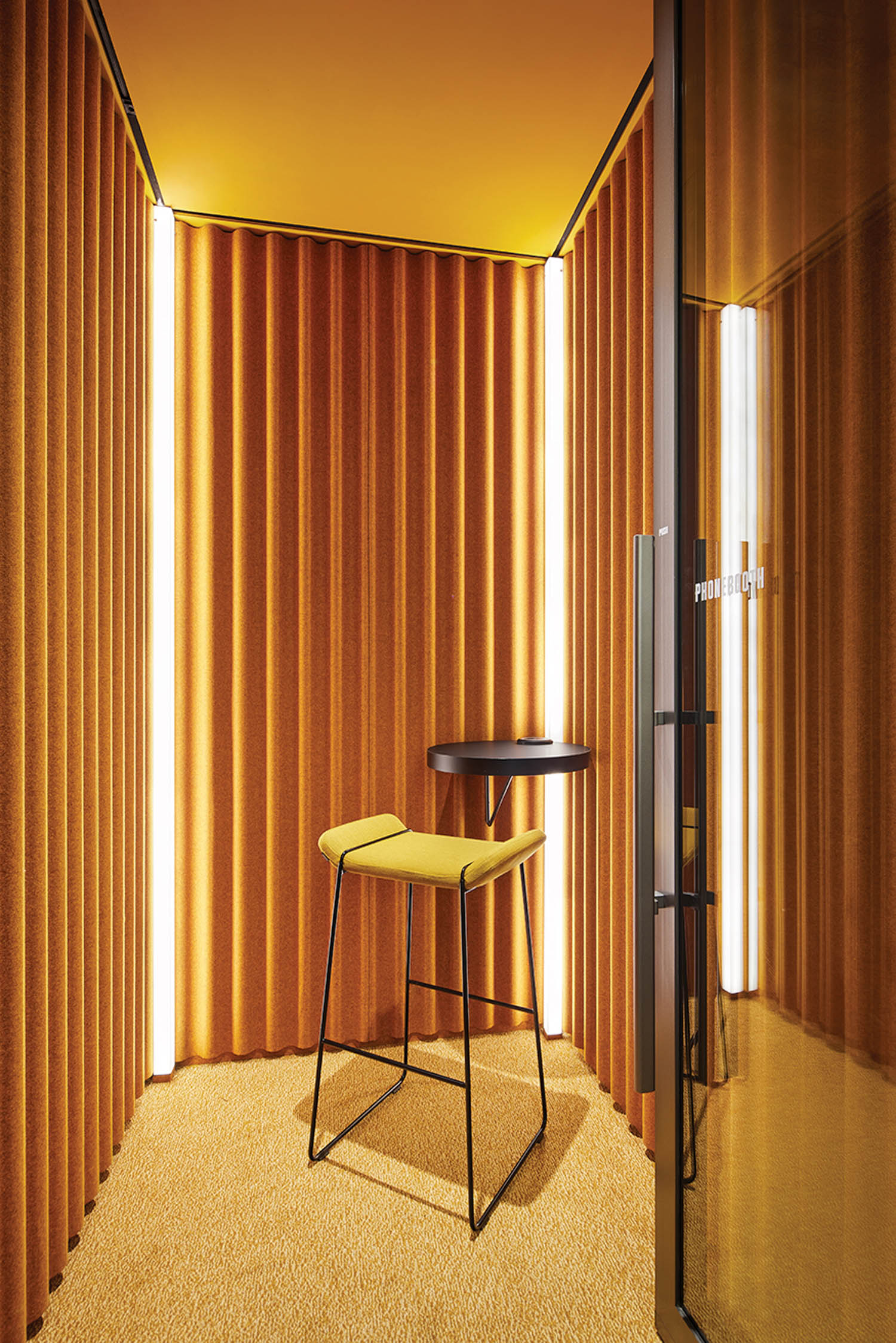 bright yellow booth area with matching chair and drapes