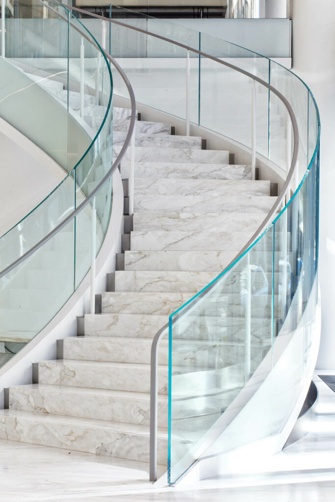 staircase with marble steps and leather handrails