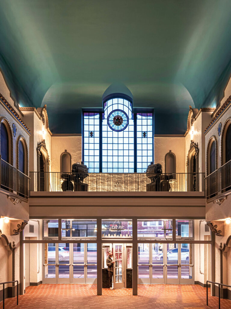 Modern Spanish style foyer with preserved stained glass windows.