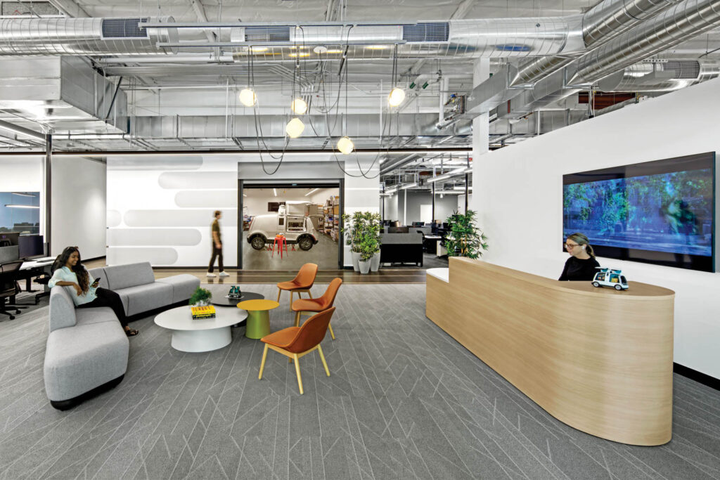 reception area with a wood desk and orange chairs