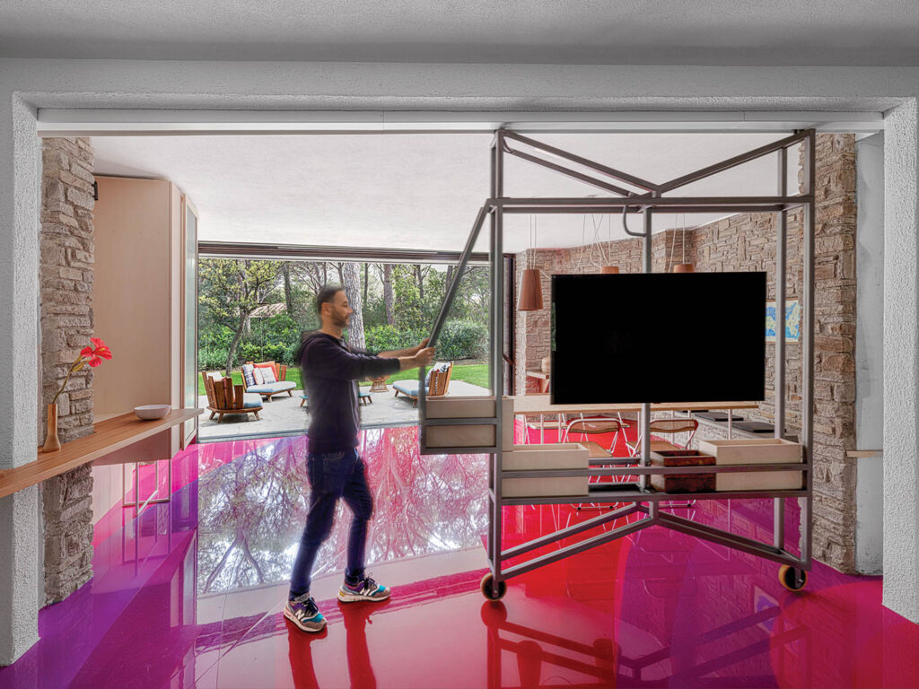 A custom-made steel media unit slides out from a living area wall to reveal the television.