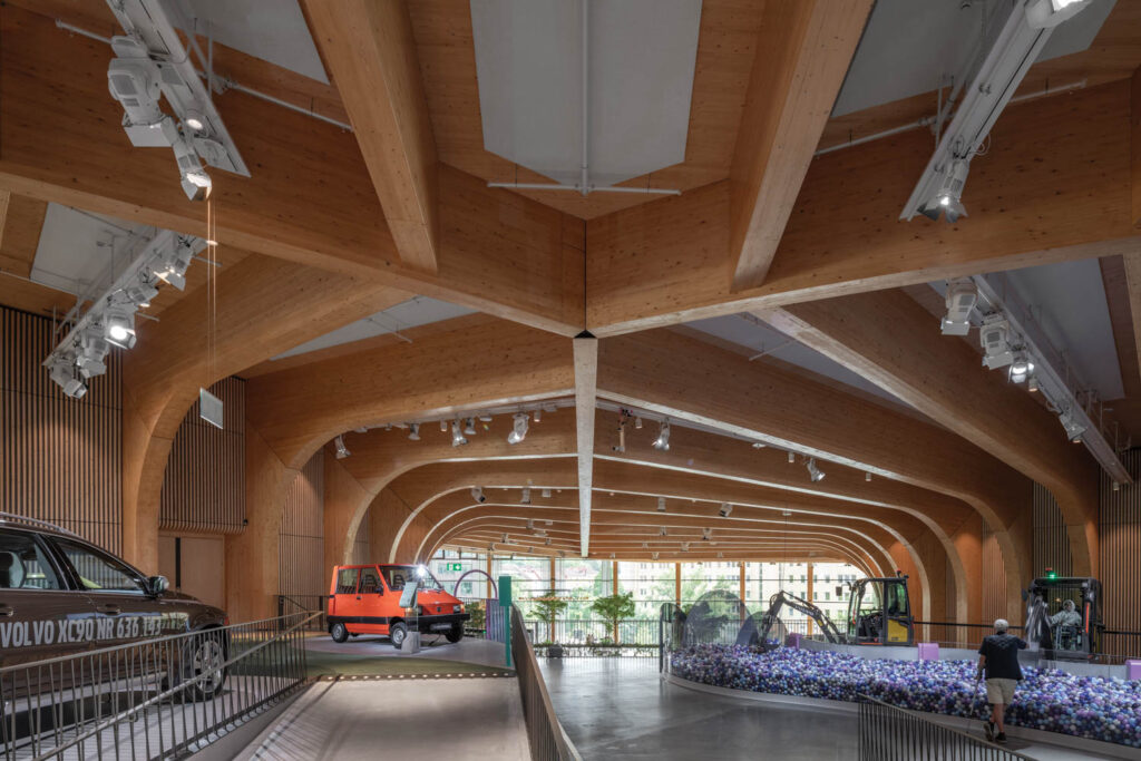 the world of volvo center with expansive ceilings and cars inside