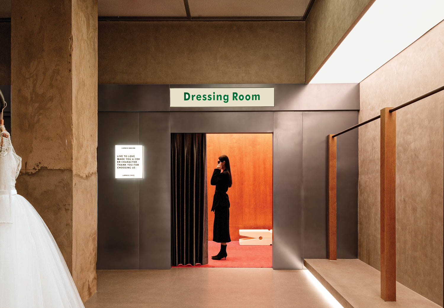 dressing room with red curtains and concrete walls, resembling a photo booth