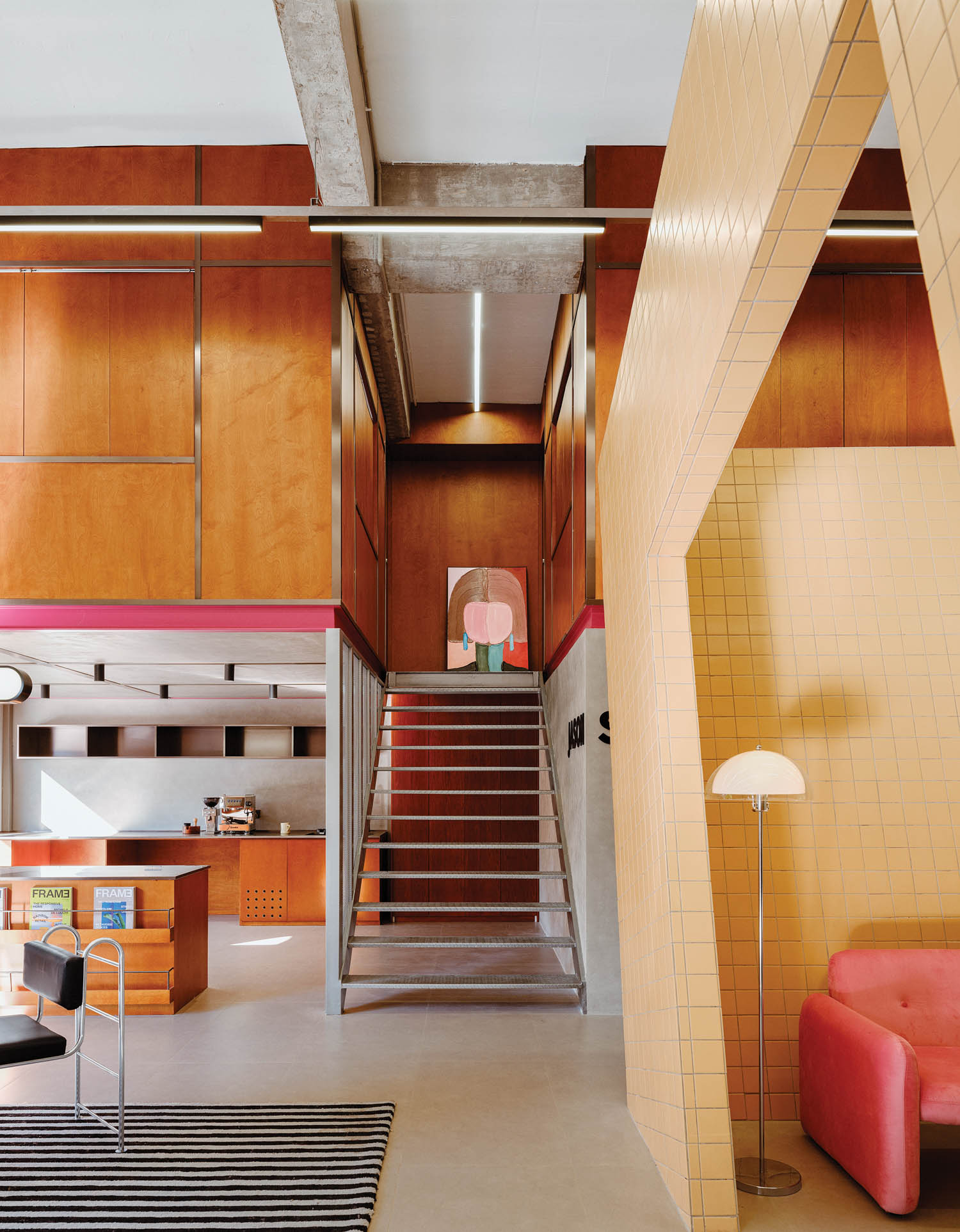 steel stairway with colorful paintings and wooden walls